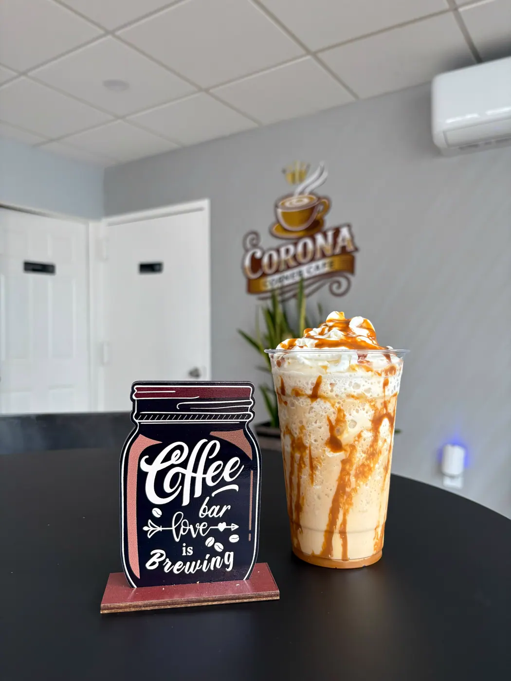 Caramel topped cold drink inside Corona Corner Cafe